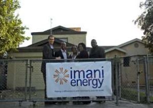 people holding the Imani Energy, Inc. banner